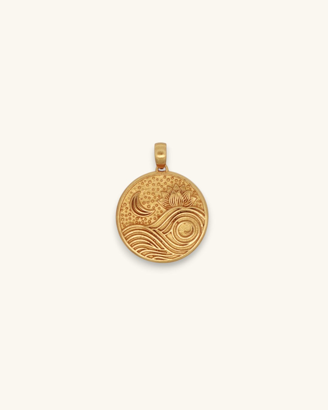 Gold plated brass round pendant showing embossed lotus flower, crescent moon, and wave motifs on white background