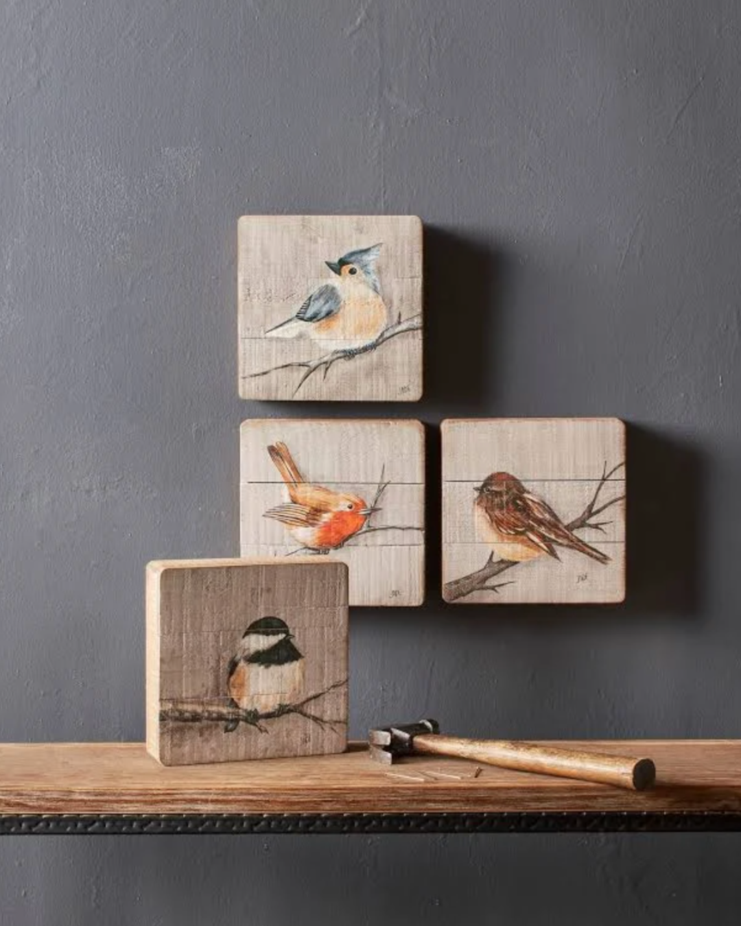 Rustic wood songbird plaque set of 4 clustered on a gray wall, showing a stacked and offset wall arrangement