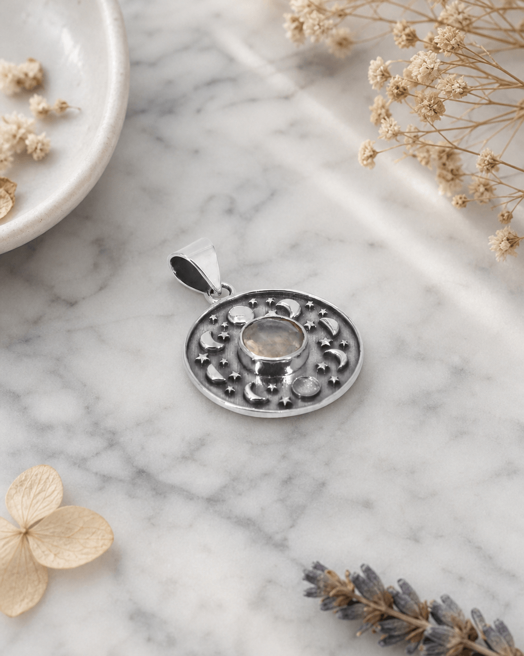 Sterling Silver Moon Phase Celestial Pendant with Moonstone — charms & pendants, editorial marble lifestyle photo