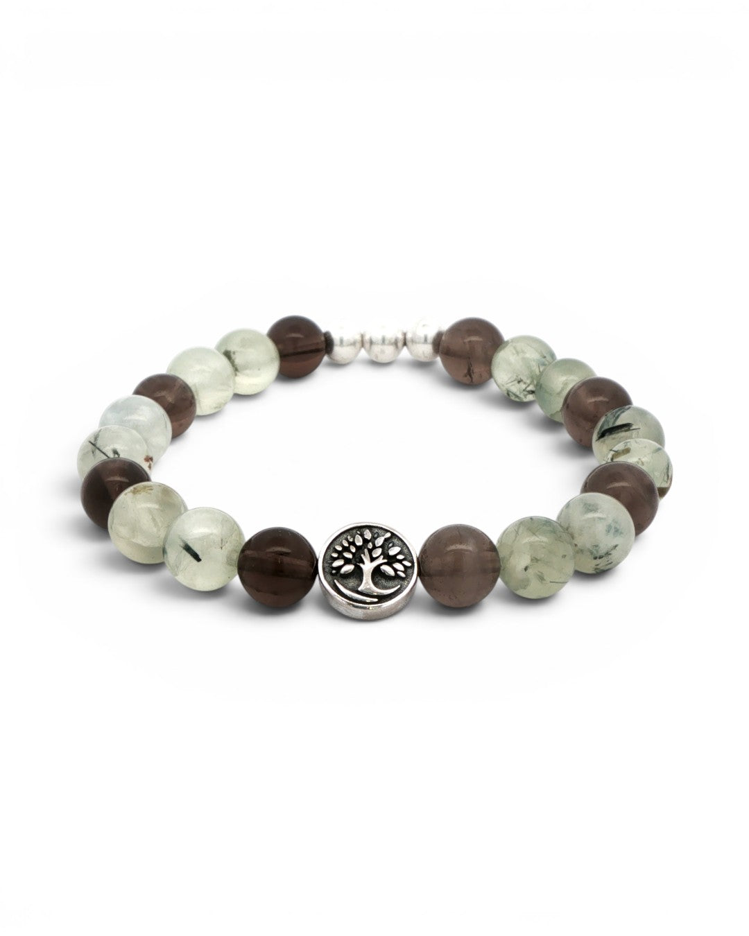 Angled view of Tree of Life bracelet with silver tree charm centered at front, flanked by smoky quartz and prehnite gemstone beads