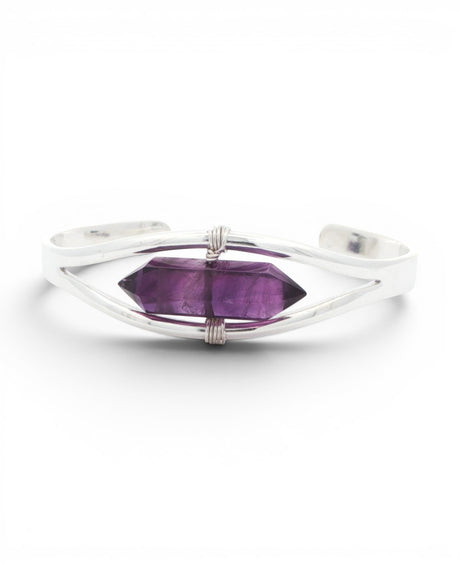 Front detail of amethyst crystal point bracelet with wire-wrapped silver bindings holding the double-terminated stone
