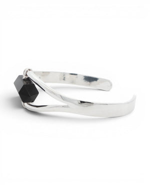 Side profile of silver black onyx cuff bracelet showing the open curved band and wire-wrapped stone