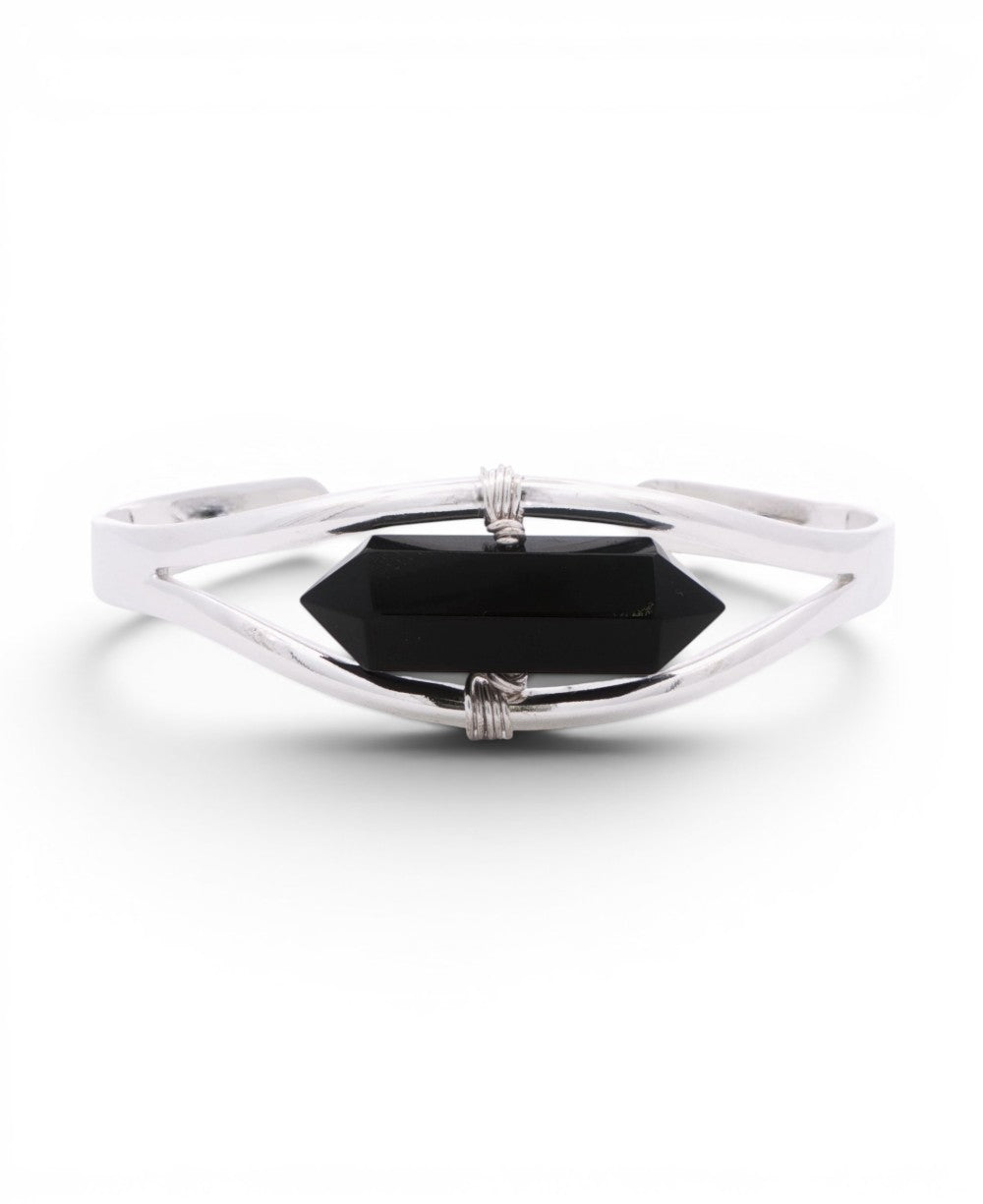 Black onyx crystal point set in a minimalist silver cuff bracelet, front view with wire-wrapped bindings