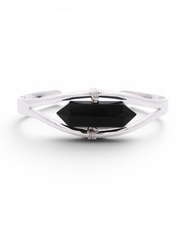 Black onyx crystal point set in a minimalist silver cuff bracelet, front view with wire-wrapped bindings