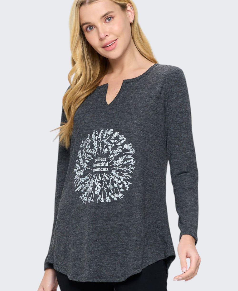 Charcoal grey long sleeve tunic top with white floral wreath graphic reading collect beautiful moments, close front view