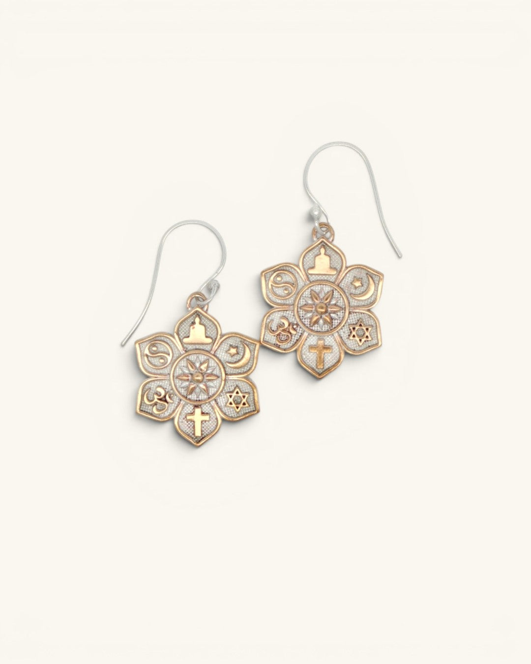 Coexist Harmony Earrings pair at an angle on white background, gold interfaith symbols and textured silver mandala clearly visible