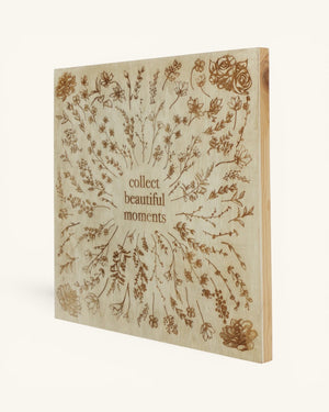 Collect Beautiful Moments engraved wood wall sign in angled view showing panel thickness and natural wood grain along the frame edge