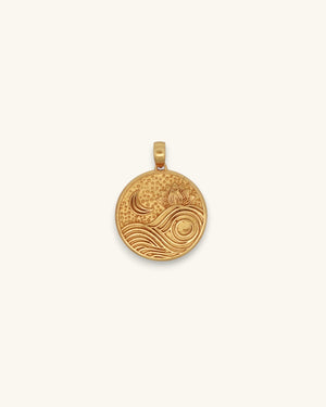 Gold plated brass round pendant showing embossed lotus flower, crescent moon, and wave motifs on white background