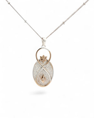 Infinite Lotus & Flame Pendant hanging on a silver satellite chain against white, full pendant and chain visible
