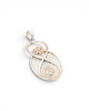 Infinite Lotus & Flame Pendant at a tilted angle on white background, showing the textured silver oval and gold-tone accents