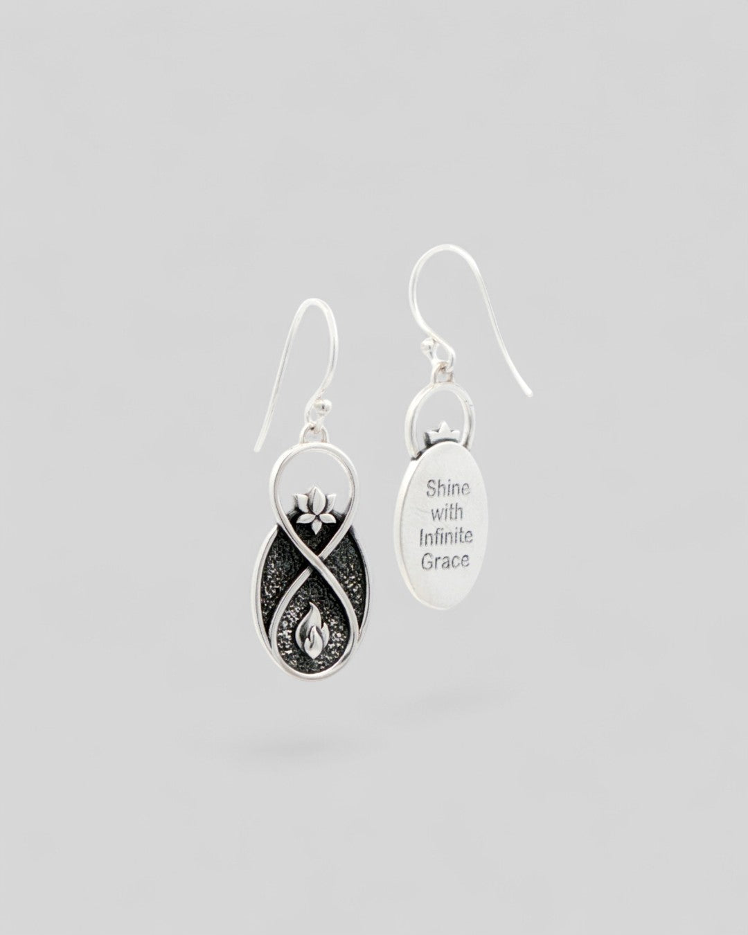 Lotus Infinity Flame earrings showing front and engraved back reading Shine with Infinite Grace on oval silver disc