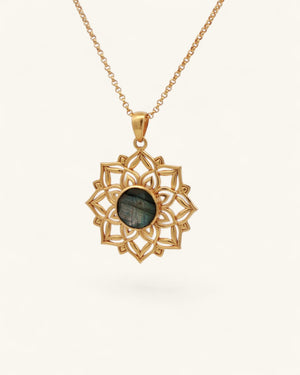 Gold lotus mandala pendant with labradorite gemstone hanging on a gold rolo chain against a white background