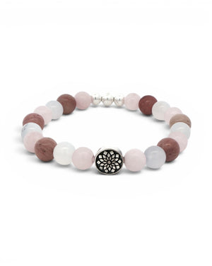Mandala gemstone stretch bracelet angled view on white, engraved silver mandala charm bead facing forward among rose quartz and rhodochrosite beads
