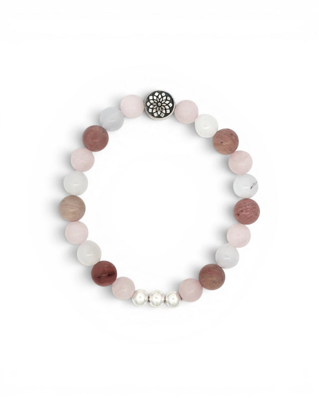 Mandala gemstone stretch bracelet flat lay on white, showing rose quartz, rhodochrosite, and chalcedony beads with silver mandala charm