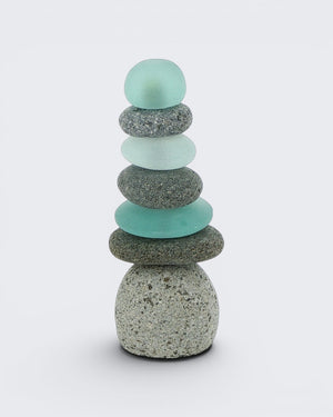 Single tall mini stacked stone cairn with seven alternating grey speckled stones and teal sea glass pieces, front view