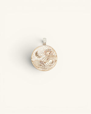 Round silver-plated bronze moon and wave lotus pendant, flat overhead view showing engraved celestial design
