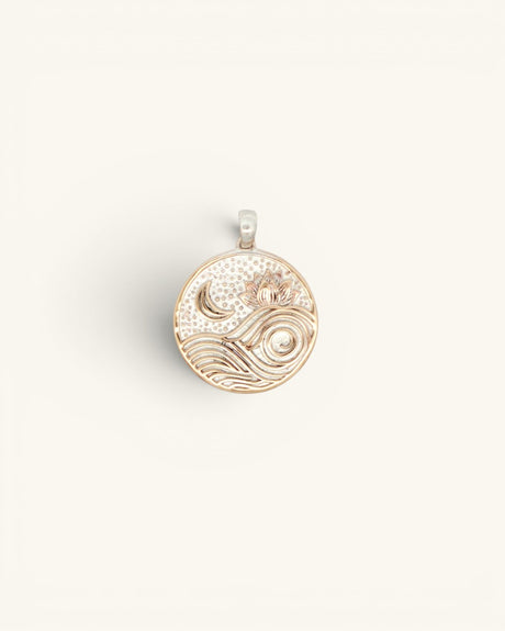 Round silver-plated bronze moon and wave lotus pendant, flat overhead view showing engraved celestial design