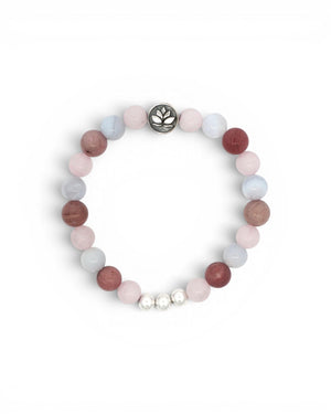 Love Connection Lotus Bracelet flat lay on white, rose quartz, rhodochrosite, and blue-grey beads with silver lotus charm, top view