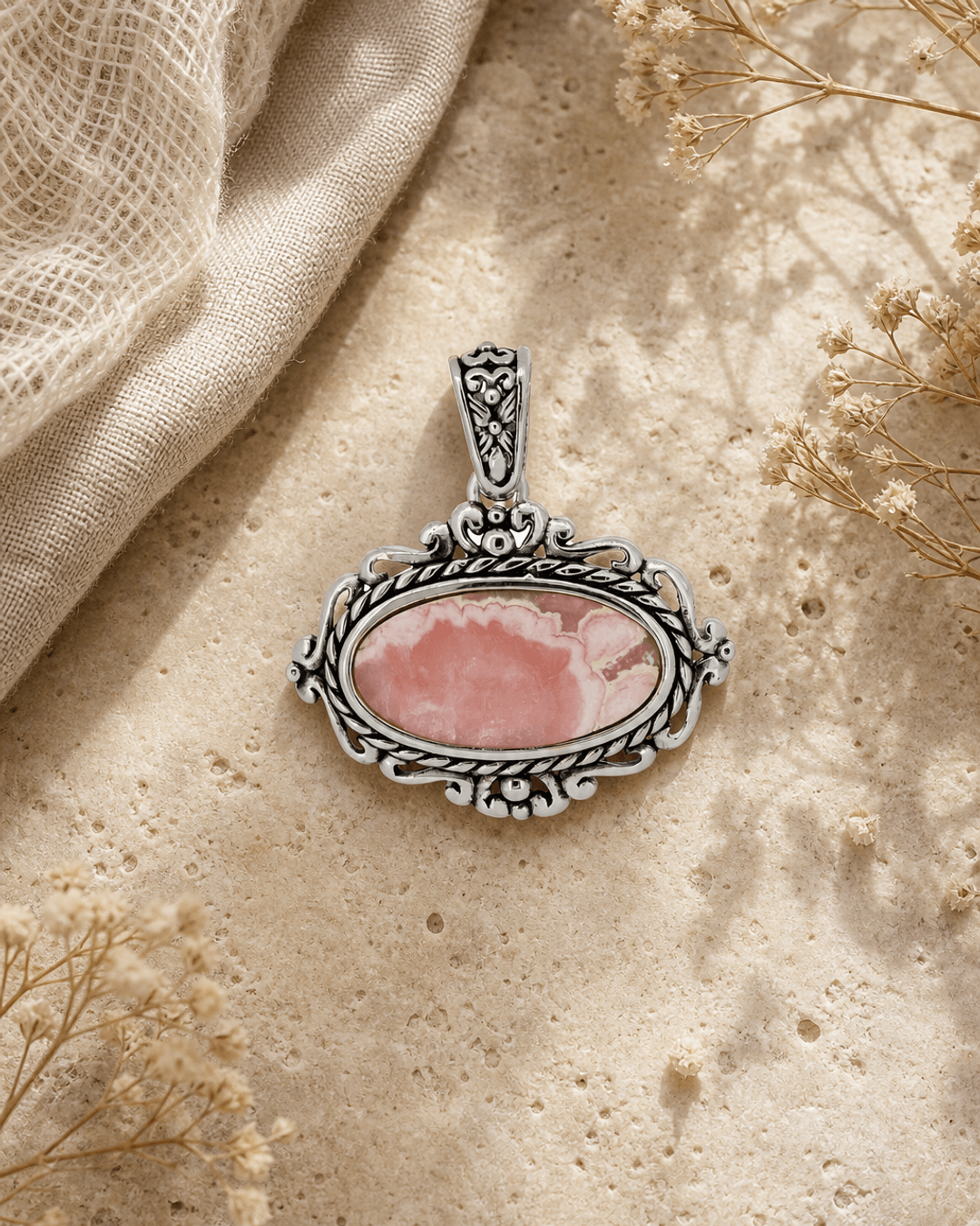 Sterling Silver Rhodochrosite Pendant — charms & pendants, editorial travertine lifestyle photo