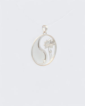 Yin yang lotus pendant back view in uniform silver showing mirrored yin yang symbol with lotus flower relief on the right side
