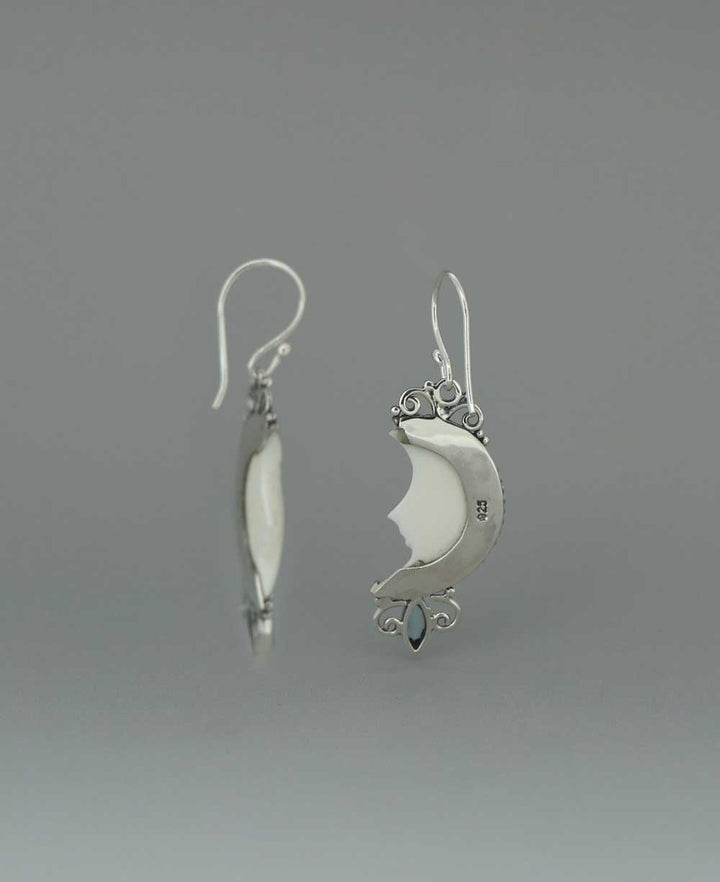 Bali-Crafted Sterling Silver Earrings with Carved Moon Face and Blue Topaz - Earrings