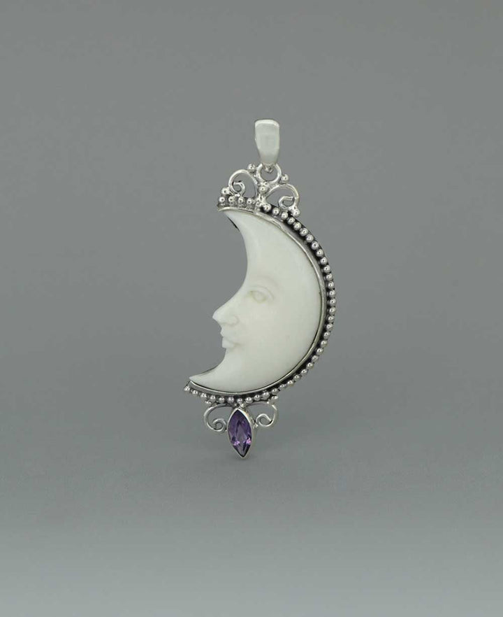 Bali-Crafted Sterling Silver Pendant with Carved Moon Face and Amethyst - Charms & Pendants